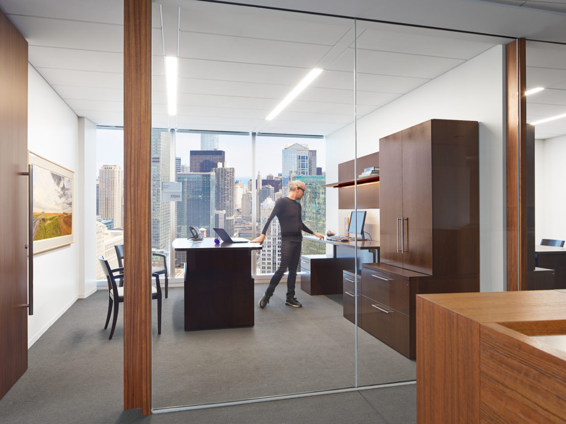 McDermott private office with wood case goods and height adjustable desks.